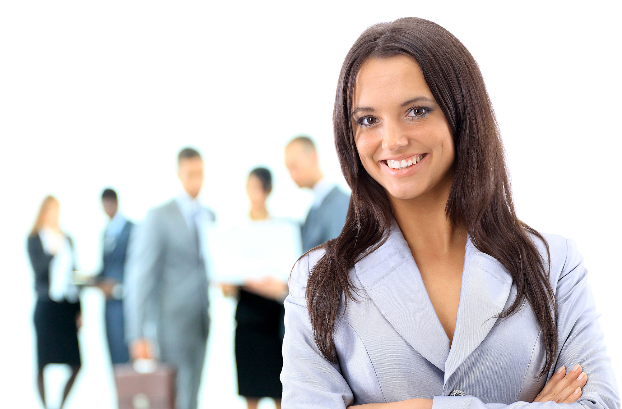 Lady smiling with several people in the background.