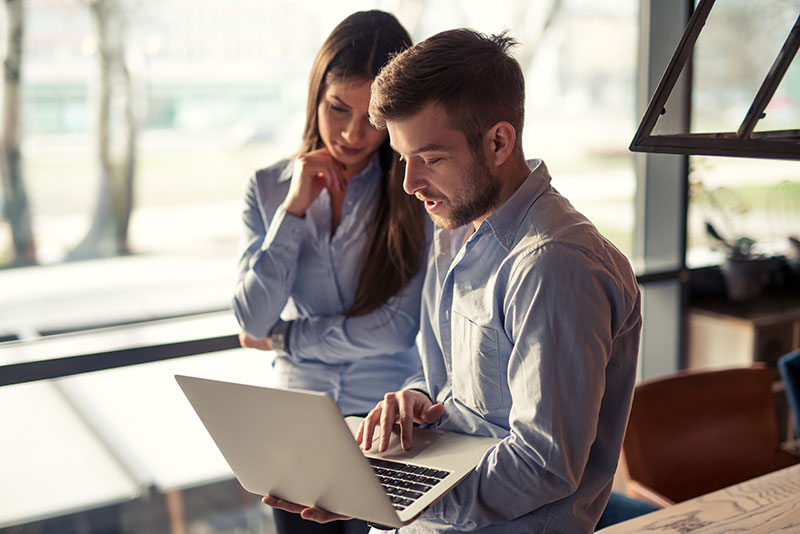 People in front of a laptop