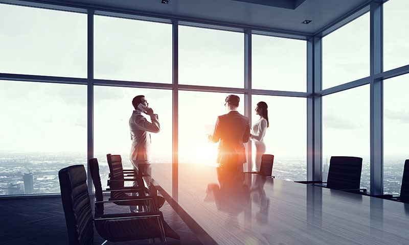 Three people talking in an office