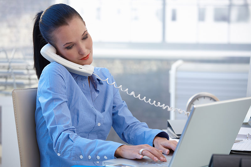 Lady speaking on landline phone