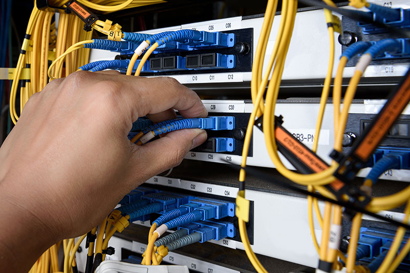 Hand pulling cables in a datacenter